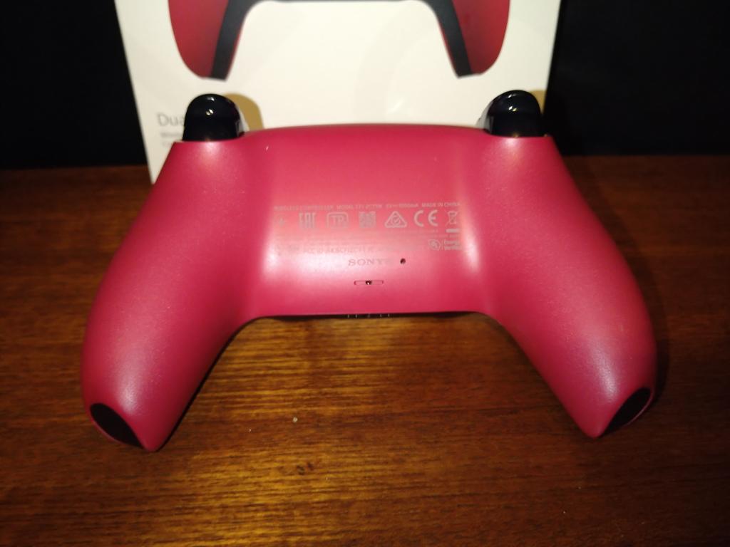 The back of the Cosmic Red DualSense